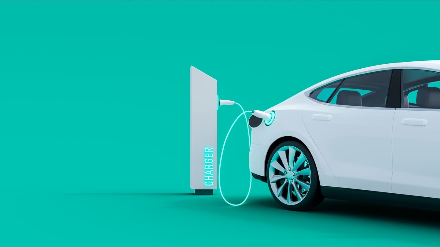 White electric car connected to a charging station with glowing cable against a turquoise background.